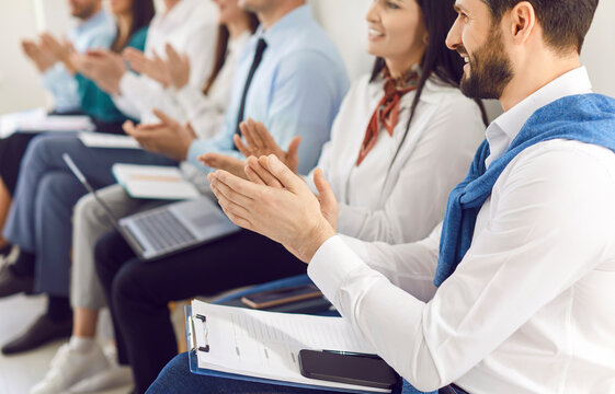 Smart business audience office people group smiling applauding sitting clapping hands at corporate training seminar meeting to show appreciation, applause awarding businesspeople, meeting together