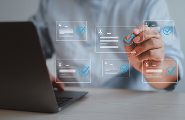 Male businessman doing online survey and digital form checklist with laptop computer, document...