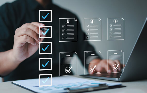 Male businessman doing online survey and digital form checklist with laptop computer, document management system, online document database and file management process.