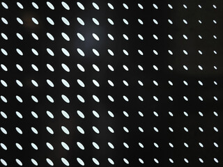 Modern abstract pattern with white ovals on black background, creating striking visual effect. This design can be used in various creative projects