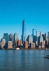 Fototapeta premium Photo Of a New York City Skyline Over Water Under a Clear Blue Sky