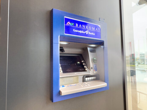 Blue bankomat atm for gorenjska banka in bright indoor setting