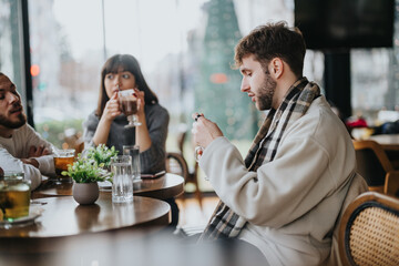 Three friends gather in a cozy cafe to socialize and enjoy warm beverages, representing friendship, relaxation, and a comforting indoor setting.