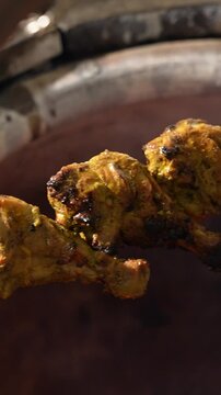 Tangdi kebab being Butter on top of a hot Indian Tandoor