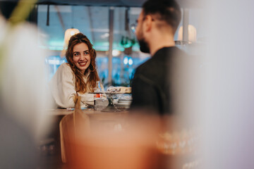 Two friends enjoying a warm conversation at a stylish lounge bar, sharing laughs and drinks amidst...
