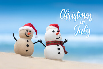 Christmas in July sale template design with a snowman and a sandy snowman on a beautiful beach, with hands held together
