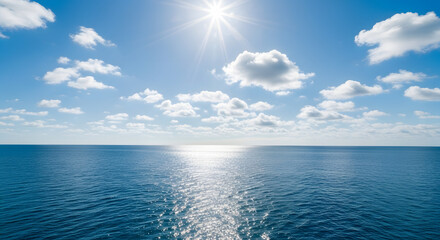 Obraz premium Bright Sun Shining Over Calm Blue Ocean with Sparkling Water Reflection & Clear Sky