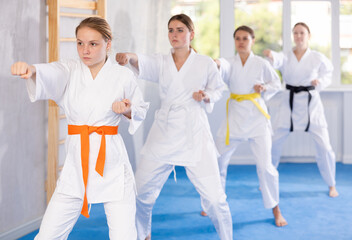 Kata karate woman teacher conducts female classes and performs movements and fighting techniques...