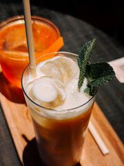 Refreshing cocktails served with ice and mint at a vibrant bar on a sunny day