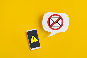 exclamation mark on mobile phone with forbidden mail on real white speech bubble paper cut on...