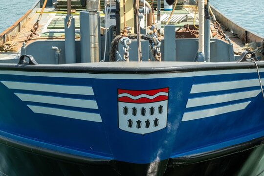 Bow of a blue tug boat showing coat of arms of sursee, switzerland