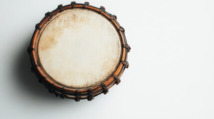 Close-up view of a traditional hand drum displaying its intricate design and craftsmanship on a light backdrop.
