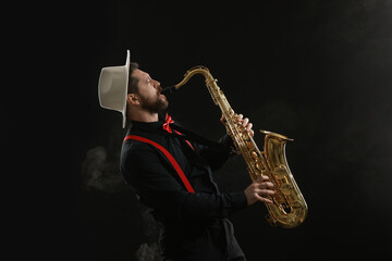 Professional musician playing saxophone on black background with smoke