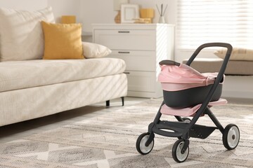Doll stroller in room, space for text. Kid's toy