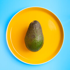 avocado on a yellow plate