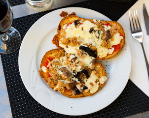 Delicious sandwich with tuna and mushrooms under sauce