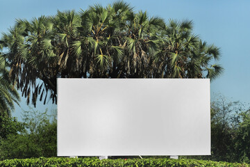 billboard in green garden outdoor advertising, mockup billing board in front of a sky. and green...