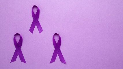 Purple ribbon held, symbol of support. Purple Epilepsy Awareness Day