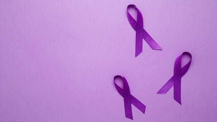 Purple ribbon held, symbol of support. Purple Epilepsy Awareness Day