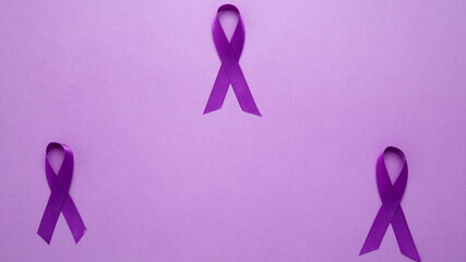 Purple ribbon held, symbol of support. Purple Epilepsy Awareness Day
