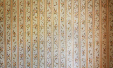 Old wallpaper on the wall. Old wallpaper for texture or background.