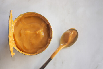 fresh Dulce de leche made from canned condensed milk on marble table