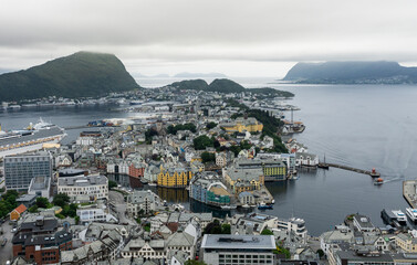 View of the historic city center of Ålesund on the west coast of Norway, with the surrounding fjords and islands under a cloudy sky