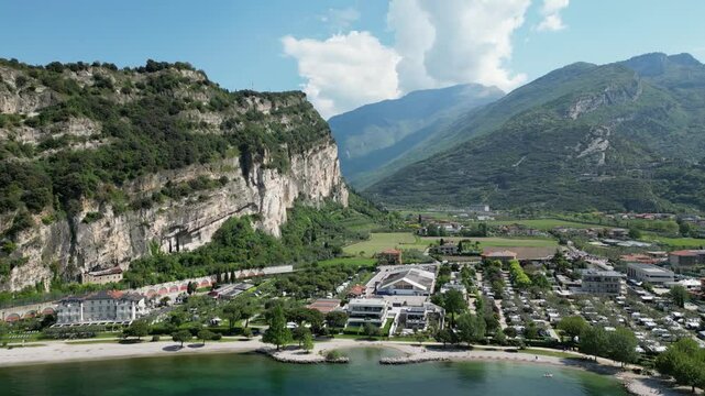 Aerial view of Riva del Garda and Torbole with river Sarco. View of sailboats, surfers and camping places on northern part of Lake Garda.