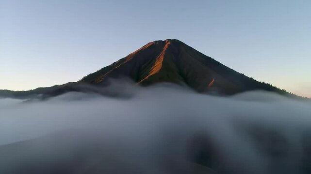 Majestic Mountain Peak Emerging Above Sea Of Clouds At Sunrise
