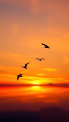 Fototapeta premium Silhouetted birds in flight during a vibrant sunset