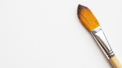 Fototapeta premium A paintbrush rests on a clean canvas, inviting imagination and creativity in an artistic environment.