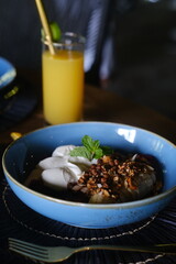 Fruit Bowl with Yogurt, Granola, and Mint, Served with a Glass of Juice