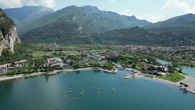 Aerial view of Riva del Garda and Torbole with river Sarco. View of sailboats, surfers and camping places on northern part of Lake Garda.