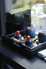 Coffee Capsules on Upside-Down Cups Next to Portable Coffee Machine on Wooden Tray