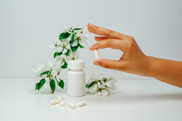 Allergy pills close-up. Space for text. Man holds pills in hand