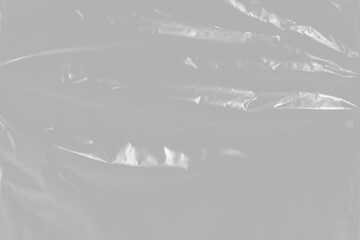 plastic overlay texture of realistic crumpled transparent plastic film wrap on black background,wrinkled stretched plastic effect.	