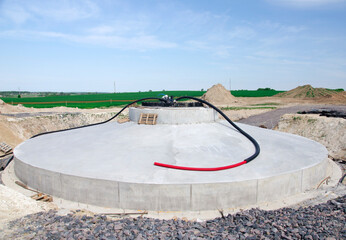 Construction site and agriculture field. Preparation of a wind turbines with concrete and steel. building wind turbines. wind turbine base and Pile of sand and Gravel for construction.