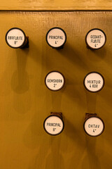 Old buttons on the church organ correspond to the musical themes to be played