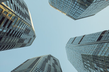 Low angle view of the four skyscrapers under the blue sky