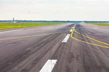 Empty runway, awaiting the next flight. Precise markings guide aircraft on the tarmac
