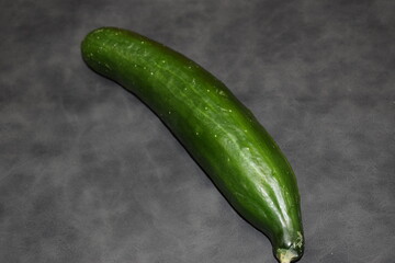 green cucumber on a wooden background