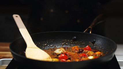 Sauteed Cherry Tomatoes and Olives in Frying Pan.