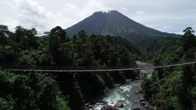 Majestic Volcano Overlooking Lush Forest And Flowing River Landscape