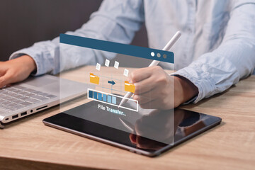 A woman transfer files from tablet computer to laptop. Backup, copy file and media or exchange data...
