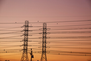 The silhouette electric power line at the sunset