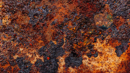 Black soot stains on rough rusty surface, metal corrosion close-up, grunge textured background