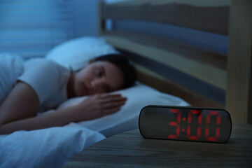 Frustrated young woman suffering from insomnia on bed indoors, selective focus