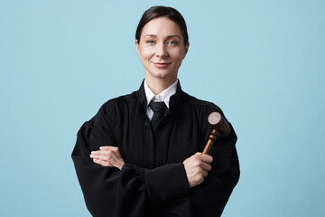 Judge with mallet on light blue background