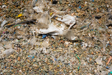Plastic soup; lots of plastic and other trash washed ashore on the beach of Crete