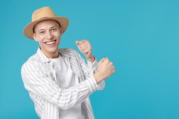 Happy man dancing on light blue background. Space for text